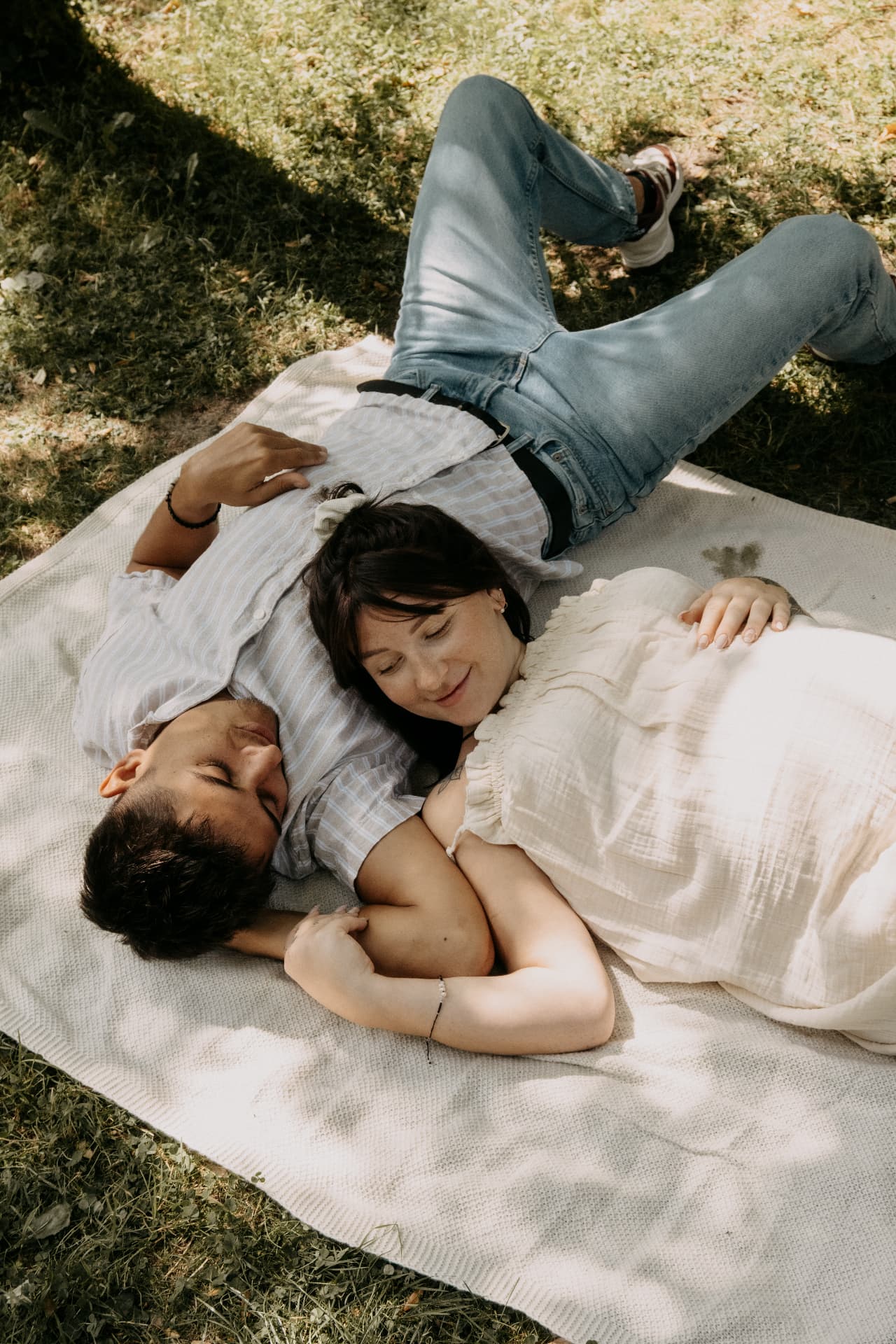 Couple allongé dans l'herbe, en attendant bébé